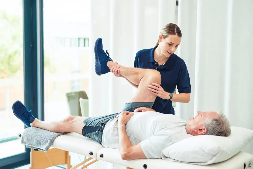 Revitalising Recovery: Effective Rehabilitation Strategies for Muscle Injuries 3 Physiotherapist assisting a patient with muscle recovery exercises Livingston