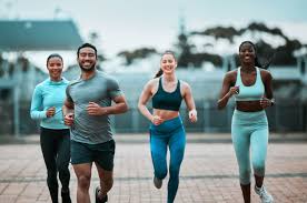 Sculpting Sleek Arms: The Essential Role of Cardio in Toning Without Bulking Up 3 image of people running to incorporate cardio Livingston exercise into their life to help tone arms and body.